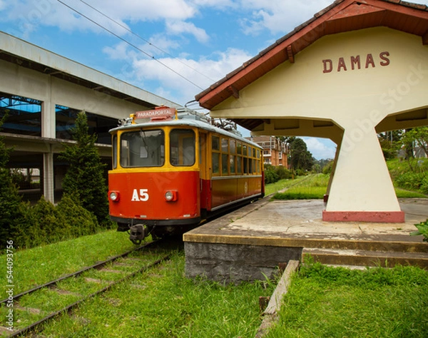 Fototapeta Tram  passing by the station "Damas" in Campos do Jordão, Brazil. Sign written "Portal Stop" in Portuguese, name of the final station