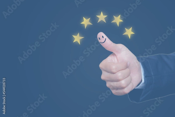 Fototapeta Customer satisfaction scoring concept, five-star rating, thumbs up to show the smiling face icon for satisfied with the quality of excellent service.