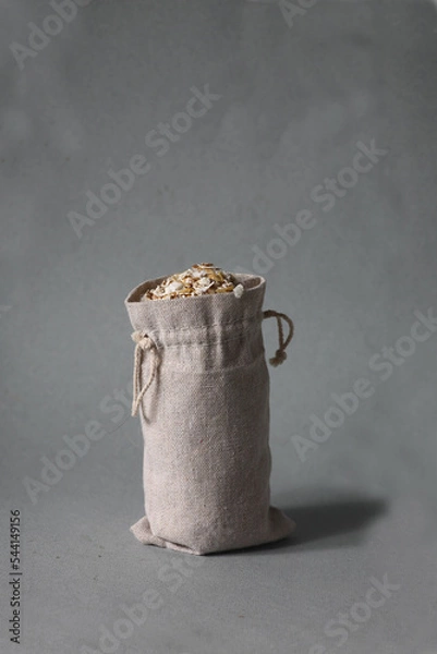 Obraz bag of oatmeal isolated on gray background