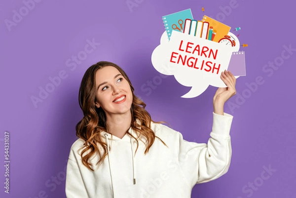 Fototapeta student girl holding speech bubble with text learn english and illustration isolated on lilac background