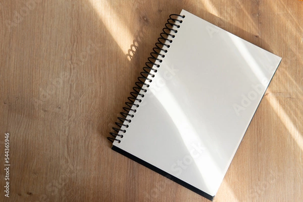 Fototapeta notepad with blank pages on a wooden table