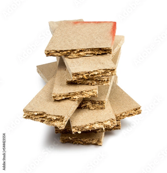 Fototapeta a pile of broken untreated mdf slabs of brown color on a white background close-up