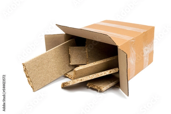 Fototapeta a pile of construction debris (plastic, MDF, aluminum, cardboard) in a brown cardboard box on a white background