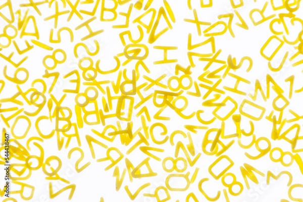 Fototapeta Curly vermicelli for children in the form of letters on a white background.