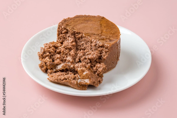 Obraz Soft pate for cat on a white plate over pastel pink background. Canned pet food of minced meat on a feeding plate closeup. Feed for carnivore domestic animals. Сat food concept.