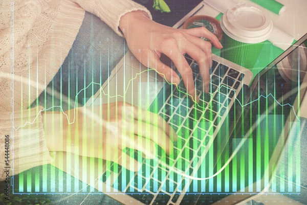 Obraz Double exposure of woman hands typing on computer and forex chart hologram drawing. Stock market invest concept.