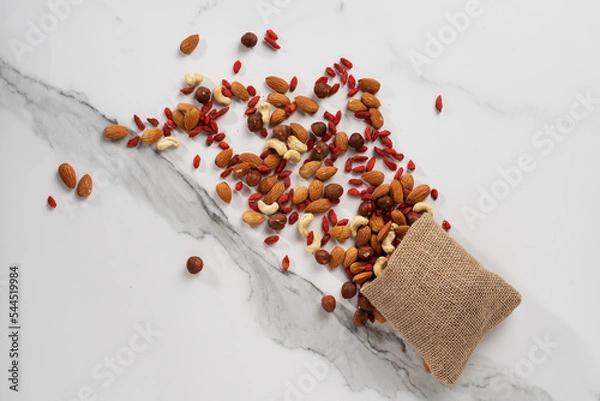 Obraz the nut mixture is scattered from the bag