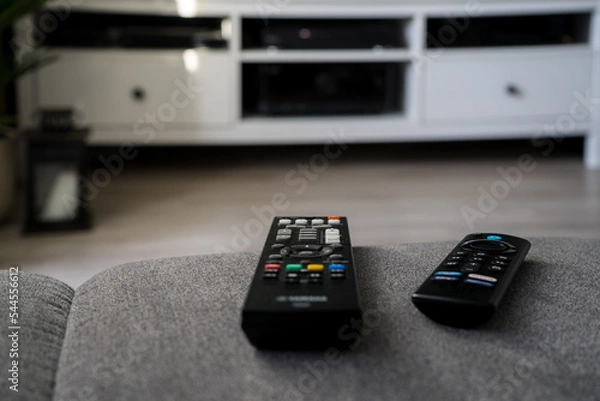 Fototapeta Remote control lying in front of the TV