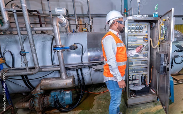 Obraz Electrical engineer inspection control panel and commissioning during pressure steam drum shutdown