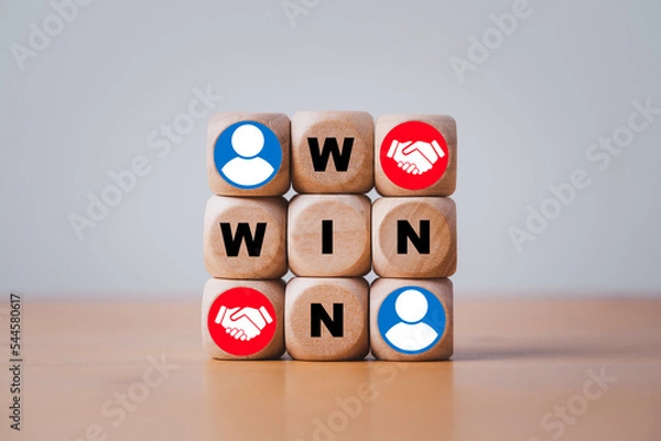 Fototapeta Win and win wording with hand shaking icon on wooden cube block for success and business deal situation concept.