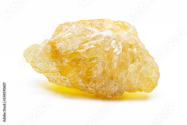 Fototapeta Raw uncut real honey yellow calcite crystal, calcium carbonate mineral with visible structure macro isolated on a white background surface 