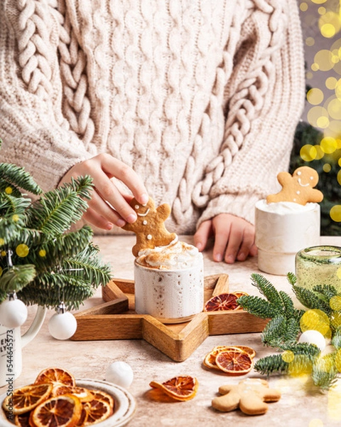 Obraz White cups of hot cocoa with whipped cream decorated with gingerbread man.