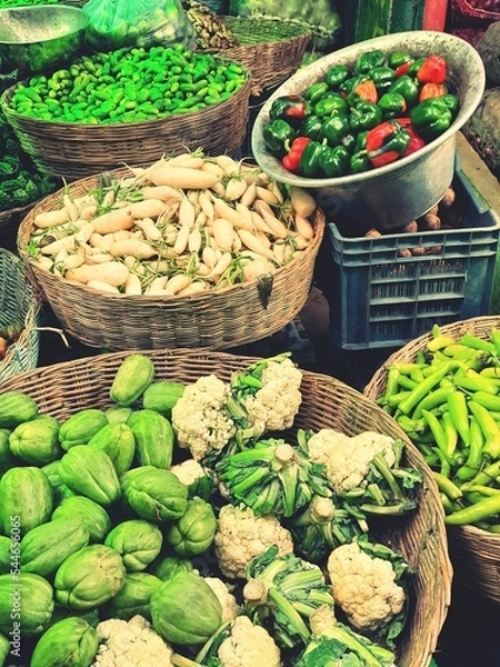 Fototapeta Vegetables in market.Cabbage,radish,chilli,capsicum in baskets