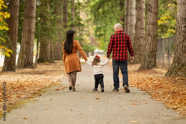 Fototapeta A full of love multi ethnic family spending precious time together in a beautiful autumn colored park