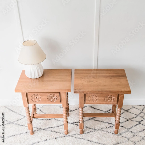 Obraz High angle view of a quaint and beautiful chest of drawers standing alone in a room lit by natural light.
