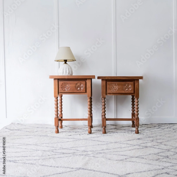 Obraz Front view of a picturesque pair of bed tables in a bright and white room illuminated under natural lighting