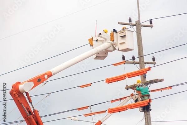 Fototapeta electrician work on crane fix high voltage elecric cable