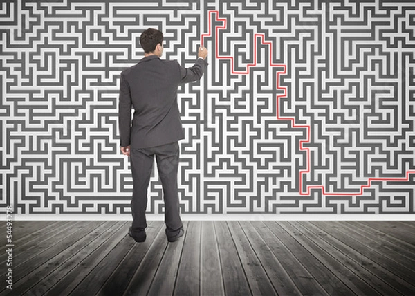 Fototapeta Businessman tracing a red line on a maze