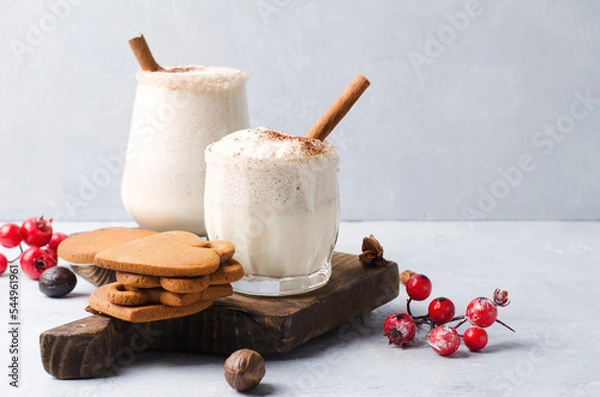 Obraz Egg nog Christmas drink on a brown background with gingerbread.