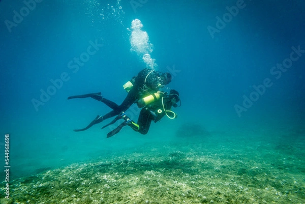 Fototapeta Son and father scuba diving in ocean