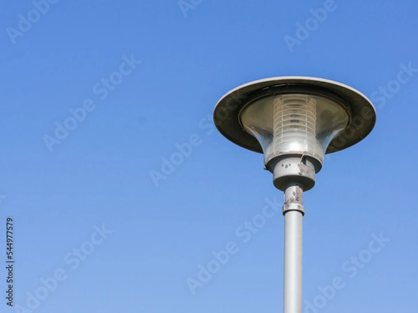 Fototapeta Lamppost with copy space on clear sky - Consumption of light concept