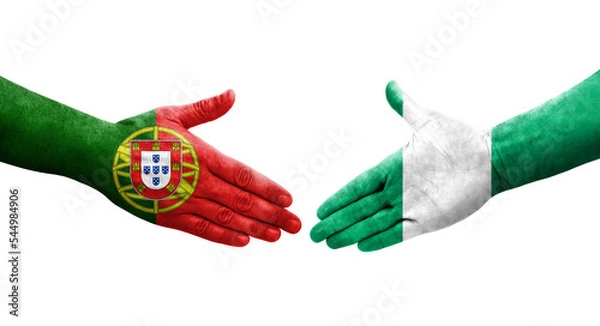 Fototapeta Handshake between Nigeria and Portugal flags painted on hands, isolated transparent image.