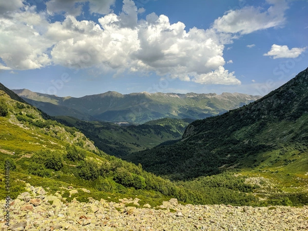Fototapeta Beautiful view of the landscape of the Caucasus Mountains against the background of the sky with clouds. Landscape of mountain green hills. Nature concept. Arkhyz, Karachay-Cherkessia, Russia