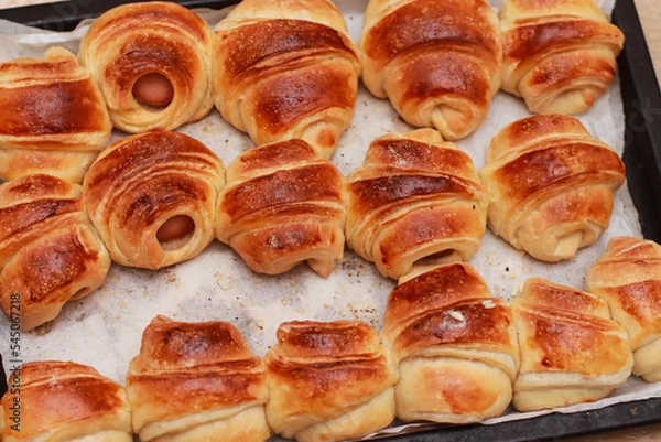 Obraz appetizing baked croissants with sausages close-up