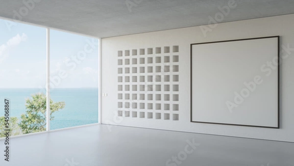 Fototapeta Empty white blank picture frame on concrete wall of bright living room in modern beach house or luxury hotel. Minimal home interior 3d rendering with sea view.