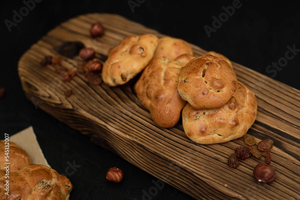 Obraz Biscuits with raisins and nuts on a wooden background