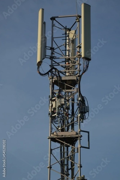 Fototapeta A Telecommunication antenna mast with blue sky background, France
