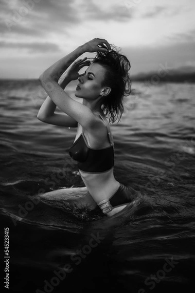 Obraz Black and white portrait of a sexy beautiful woman in the sea. Natural beauty of a young pretty girl with sexy body, clean skin and dark hair.