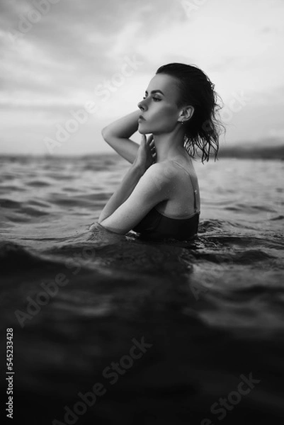Obraz Black and white portrait of a sexy beautiful woman in the sea. Natural beauty of a young pretty girl with sexy body, clean skin and dark hair.