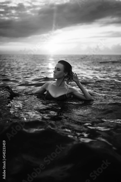 Obraz Black and white portrait of a sexy beautiful woman in the sea. Natural beauty of a young pretty girl with sexy body, clean skin and dark hair.