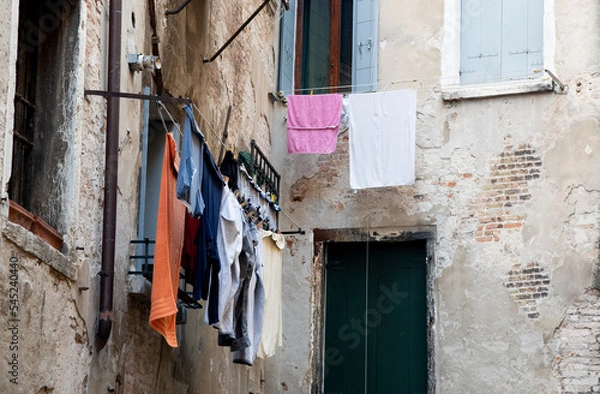 Fototapeta Home laundry hanging on a rope and drying outdoor in the clean air saving the environment.