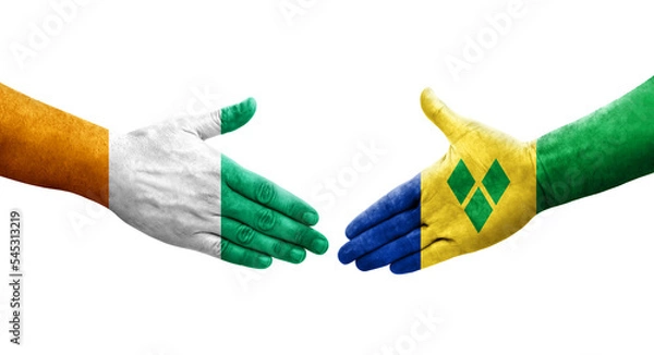 Fototapeta Handshake between Saint Vincent Grenadines and Ivory Coast flags painted on hands, isolated transparent image.