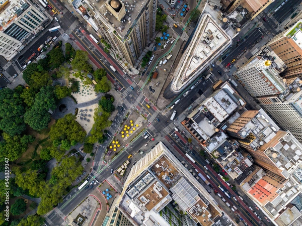 Fototapeta Aerial top down view of New York downtown street intersection and city park. Manhattan buildings with yellow cabs and cars
