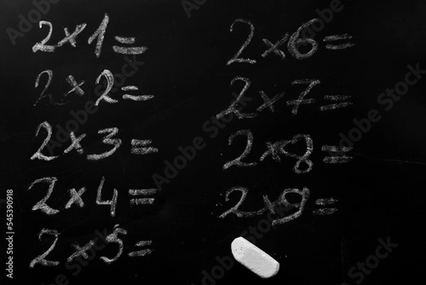 Obraz education school concept. elementary arithmetic multiplication table task written on a black chalkboard requiring a solution