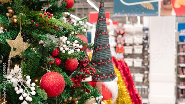 Fototapeta Christmas tree decorated in the store. Shopping for Christmas and New Year. Christmas background.