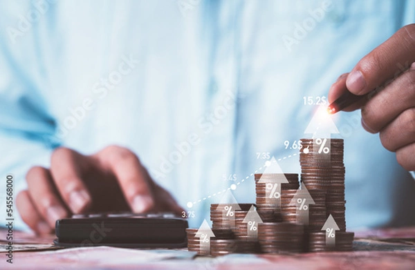 Obraz Businessman drawing increasing graph with coin stacking for increase financial interest rate and business investment growth from dividend profit concept.