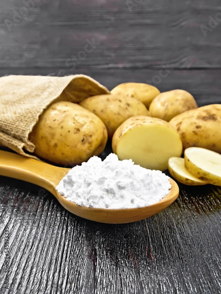 Fototapeta Starch potato in spoon on table