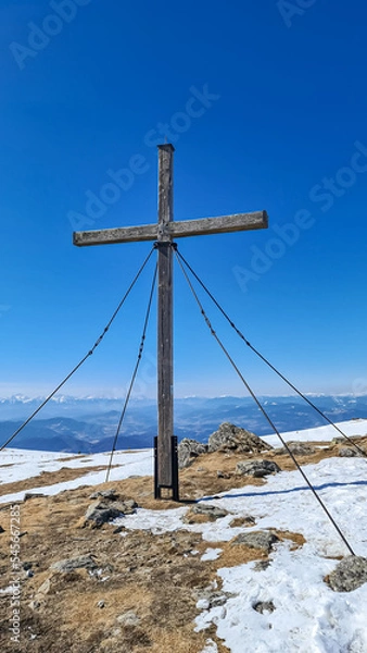Fototapeta Scenic view from the summit cross of mountain peak Zingerle Kreuz, Saualpe, Lavanttal Alps, border Styria Carinthia, Austria, Europe. Hiking trail in Wolfsberg region on sunny winter day. Ski touring