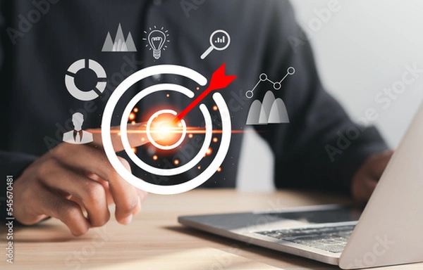 Fototapeta Businessman pointing to target icon on virtual screen. Startup business. Goal Setting Ideas, Objectives and Investment Goal Ideas