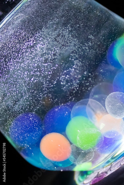 Fototapeta Colored balls in a glass with bokeh effect