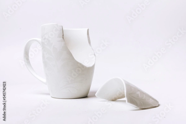 Obraz broken white cup with a pattern, on a white background
