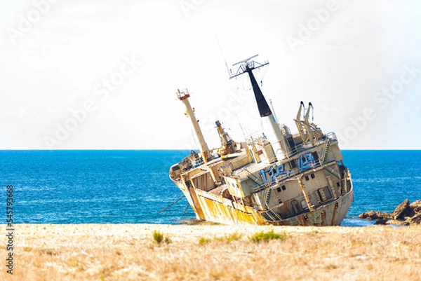 Fototapeta A large cargo ship that ran aground in the Sea Caves area of Paphos County, near Coral Bay, during a storm on December 8, 2011 after an engine failure.