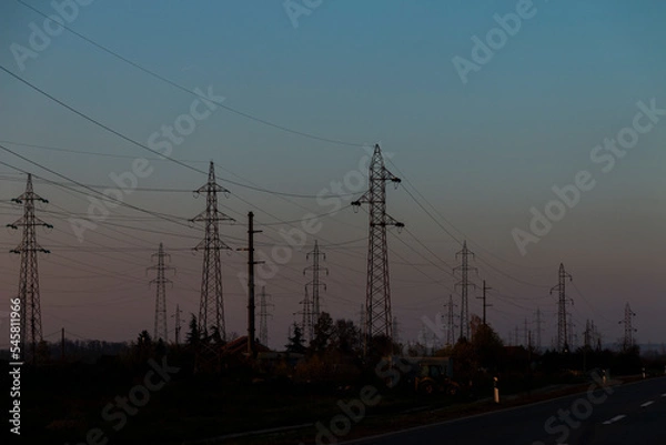 Fototapeta High voltage power lines at sunset.In future - scarcity of electricity. Due to high prices desperate people have no money to pay for electricity