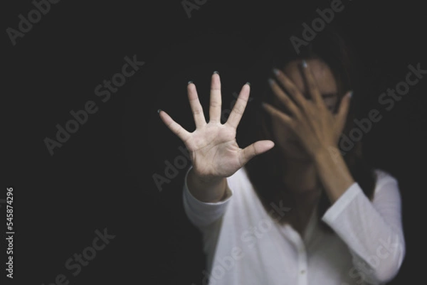 Fototapeta woman raising her hand Concept of stop violence against women, human trafficking, rape, sexual harassment of women, International Women's Day