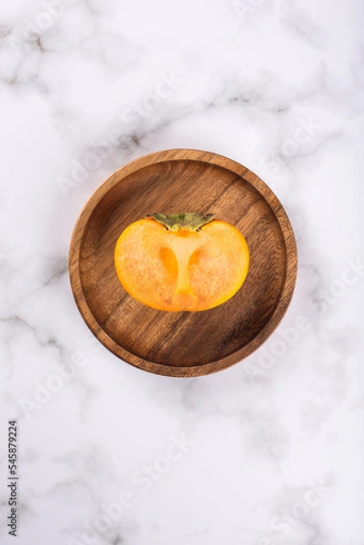 Fototapeta persimmon on a marble background
