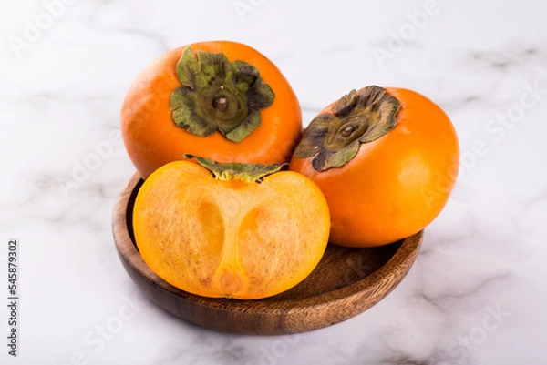 Fototapeta persimmon on a marble background